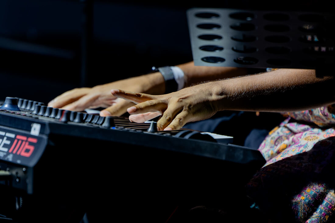 Tushar Lall's hands on the keyboard during a show