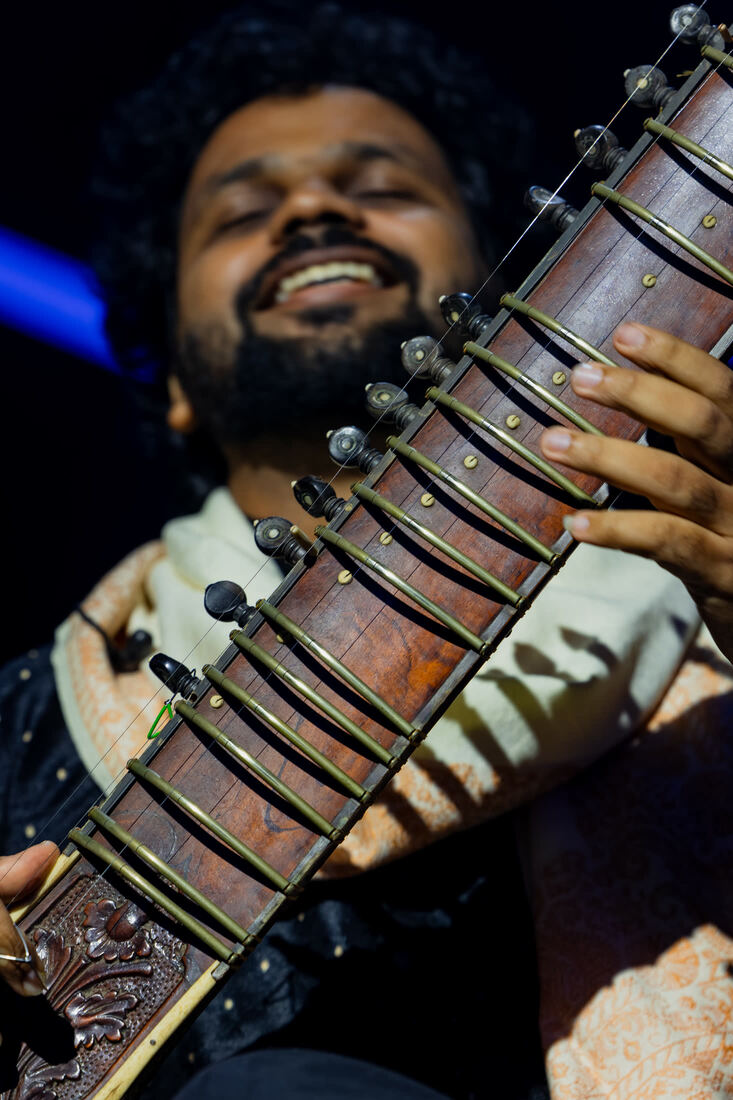 Sitarist playing, seen from below